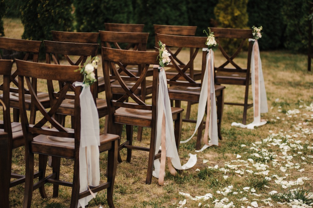 Experience the Party Plus Difference. The table on the front left showcases linens that have undergone our specialized commercial cleaning and pressing process. In contrast, the table on the back right features linens that were packaged in squares and not pressed, highlighting the clear distinction in quality.