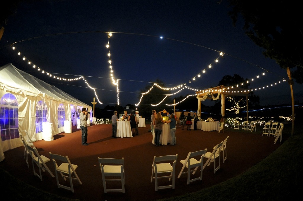 Experience the Party Plus Difference. The table on the front left showcases linens that have undergone our specialized commercial cleaning and pressing process. In contrast, the table on the back right features linens that were packaged in squares and not pressed, highlighting the clear distinction in quality.